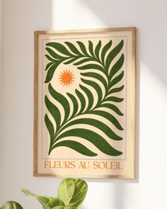 a green plant sitting in front of a white wall with the words fleurs au solei on it