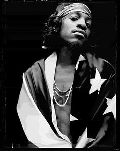 a black and white photo of a man wearing a bandana with stars on it