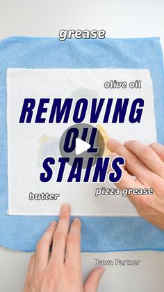 someone is removing oil stains from a towel