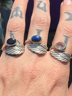 Angel Wing Rings size 7.choose from the drop down menu: ring finger: Dark Blue Sapphire middle finger: Lapis Lazuli pointer finger: Quartz Middle Finger Rings, Wing Rings, Angel Wing Ring, Middle Finger Ring, Aura Crystals, Crystals In The Home, Finger Rings, Choose One, Blue Sapphire Rings