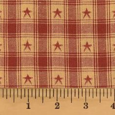 red and white checkered fabric with stars on the side, next to a ruler