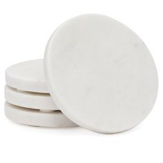 four white coasters stacked on top of each other