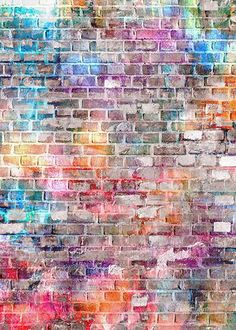 an old brick wall painted with multicolored paint