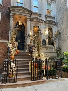 the front entrance to an apartment building decorated for halloween