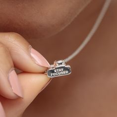 This vintage camera charm necklace is picture perfect, featuring all the assets of a classic srl camera with a single lens and flash detailing. Crafted from 925 sterling silver this three-dimensional camera pendant has been engraved with the words ‘stay focused’ on the bottom. An ideal gift for keen photographers or those who like to travel. This miniature camera adds a sense of adventure to your charm collection, bringing nostalgic memories of your best life without filters.  All our charms att