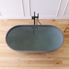 a bath tub sitting on top of a hard wood floor