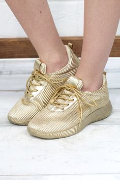 We are loving these metallic gold sneakers with ripple detailing and gorgeous laces to match the sneaker! These babes are sure to make you stand out...just like you deserve! Super lightweight and comfortable with a good footbed for support. Trendy Metallic Lace-up Sneakers, Metallic Lace-up Sneakers, Trendy Gold Low-top Sneakers, Casual Gold Lace-up Sneakers, Gold Sports Sneakers With Laces, Gold Lace-up Synthetic Sneakers, Gold Synthetic Lace-up Sneakers, Gold Synthetic Sneakers For Spring, Gold Low-top Sneakers For Spring