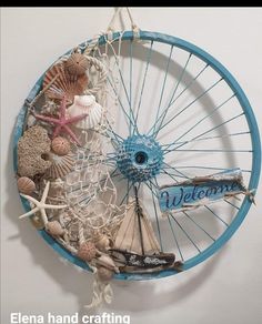 there is a wheel with shells and other things in it that are hanging on the wall