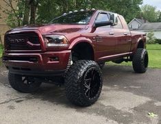 a large red truck parked in front of a house