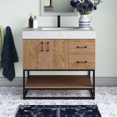 a bathroom with a sink, mirror and rug