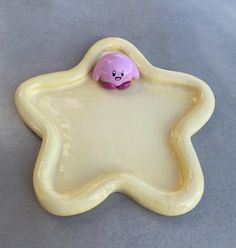 a cookie shaped like a star with a pink teddy bear on it's side