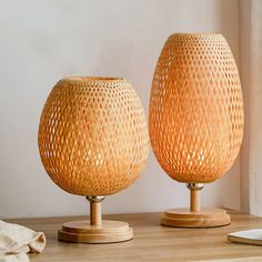 two lamps sitting on top of a wooden table