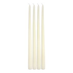 four white candles sitting next to each other