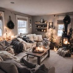 a living room filled with lots of furniture and christmas lights on the windows sill