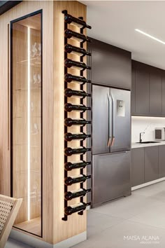 a modern kitchen with stainless steel appliances and wood accents, including a wine rack in the center