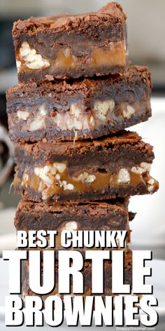 a stack of brownies sitting on top of a white plate