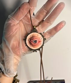 💚Get ready for Halloween with this extraordinary handmade clay eye pendant necklace! This unique piece is a must-have for anyone who loves gothic and unconventional jewelry, especially during the spookiest time of the year. The pendant features a realistic, intricately detailed eye set in a vintage-inspired brass frame, suspended on an adjustable suede cord. It's the perfect accessory to add a creepy yet stylish touch to your Halloween costume or everyday gothic attire.💚 📣Features📣    Materi Heart Eye Necklace Clay, Creepy Eye Necklace, Unconventional Jewelry, Gothic Attire, Creepy Jewelry, Clay Eye, Creepy Gift, Necklace Clay, Eye Pendant Necklace