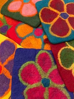 several different colored rugs are arranged on top of each other in the shape of flowers