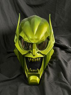 a green mask with an evil grin on it's face