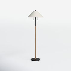 a floor lamp with a white shade on the top and a black base is shown