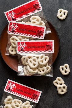 four bags of pretzels sitting on top of a plate