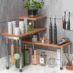 an assortment of personal care products displayed on wooden shelves in a modern bathroom with marble walls