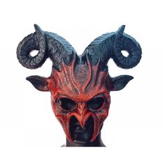 a red demon mask with horns on it's head is shown in front of a white background