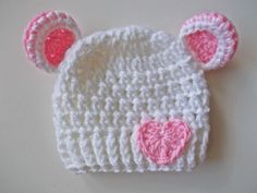 Welcome to our adorable collection of handmade baby accessories! Our crochet baby bear hat in pure white, adorned with a sweet pink heart accent, is designed to keep your little one both cozy and charming.     Exceptional Softness: Crafted from the finest yarn, this hat ensures your baby's comfort with its soft and gentle touch.   The hand-crocheted pink heart adds a touch of love and cuteness to this classic white hat.     Perfect Fit: Available in various sizes, this hat guarantees a snug and White Handmade Hats For Birthday, Cute Cream Hat For Gift, White Adjustable Beanie For Babies, Cute White Crochet Beanie Hat, Cute White Hat For Birthday, Handmade White Crochet Hat For Gift, Playful White Mini Hats For Gifts, White Playful Mini Hats As Gift, Whimsical White Mini Hat For Gifts