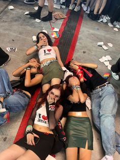 group of young women laying on the ground with their faces painted like they are lying down