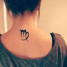 a woman's upper back neck tattoo with the zodiac sign virgo on it