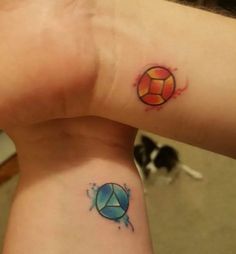 two people with matching tattoos on their arms