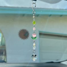 a car dashboard with a wind chime hanging from it's side