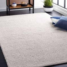 a large white rug in front of a window