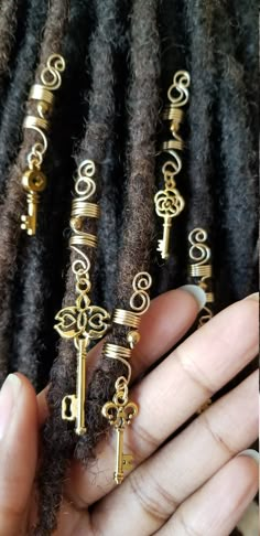 Beautiful Gold loc jewelry with a hematite bead and a skeleton key charm *Handmade *Copper *#2 Pencil Size *All key shapes and sizes are unique and may vary slightly from photos *Prices are for 1pc or 2pc *Keys charms are random and not by selection All are handmade with top quality tarnish resistant 20 gage copper wire. Why copper? Copper is a conductor of energy and works wonders when paired with healing crystals. Copper has healing properties itself. For example, not only is it a natural and Loc Assesories, Earthy Hair Accessories, Afro Hair Accessories Jewelry, Loc Accessories Black Women, Braids With Gold Accessories, Loc Charms Men, Loc Jewelry Aesthetic, Hair Jewelry Locs, Hair Accessories For Locs