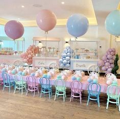 a room filled with tables and chairs covered in balloons