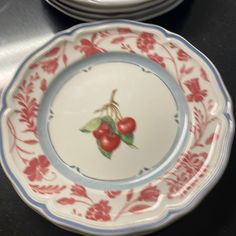 two plates with cherries painted on them