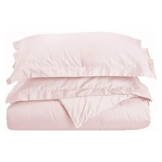 three pillows and two pillow cases are stacked on top of each other, one is pink