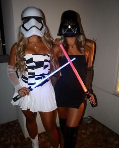 two women dressed up as stormtrooper and darth vader are standing next to each other