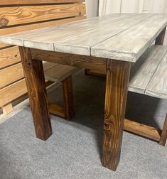 a wooden table with two benches next to it