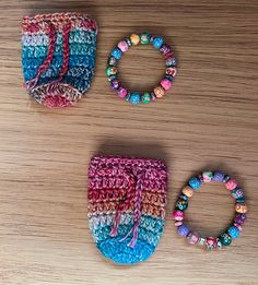 three pieces of crochet are sitting on a table with beads and bracelets