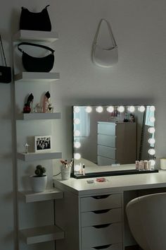 a white vanity with lights on it and a mirror in front of the counter top