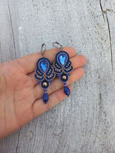 Blue beige romantic soutache earrings will perfectly accentuate your look. They will complement your everyday outfits and evening gowns.       Soutache earrings are very light! And it is their great benefit! You will not feel them in your earlaps despite their big size!      The earrings are made in soutache technique using a soutache cord, glass and crystal beads. The fixture is rhodium-plated and will not cause allergy.      If you would like to have these earrings in a different color, send me a personal message and we will talk it through. A bracelet or a necklace can also be made to complement these earrings. Feel free to contact me and we will discuss your wishes and requests.      See the other jewelry from my store. https://www.etsy.com/shop/MagicalSoutache Thank you for your inter Elegant Blue Cabochon Earrings, Turkish Earrings, Beige Jewelry, Soutache Polymer Clay, Soutache Brooch, Victorian Soutache Pattern, Textile Earrings, Soutache Headband, Soutache Earrings