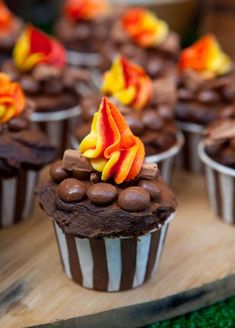 cupcakes with chocolate frosting and orange flowers on top are displayed in front of the facebook page