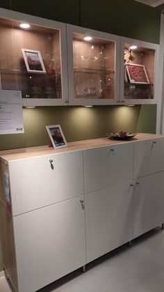 a white cabinet with some pictures on it