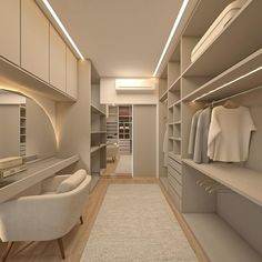 a large walk in closet with lots of white furniture and lighting on the ceiling, along with an area rug