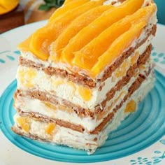 a piece of cake sitting on top of a blue and white plate with orange slices