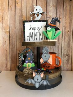 this is an image of a happy halloween display on a shelf with other items and decorations