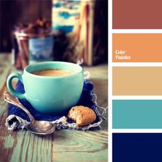 a cup of coffee and some cookies on a table with color swatches in the background