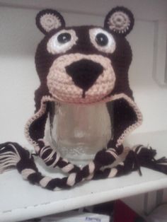 a crocheted bear hat sitting on top of a shelf