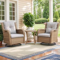 two wicker chairs sitting on top of a wooden floor next to a potted plant